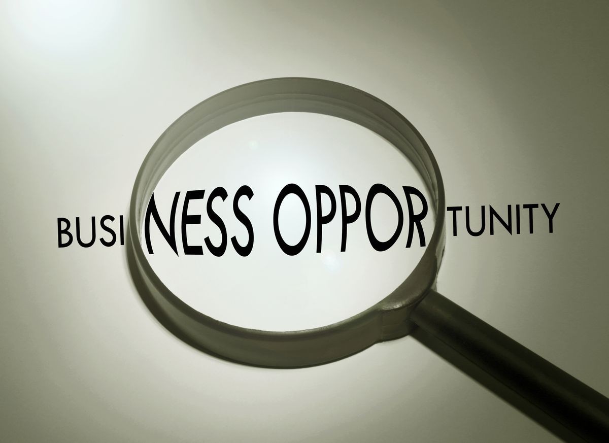 Magnifying glass with the word business opportunity. Searching business opportunity